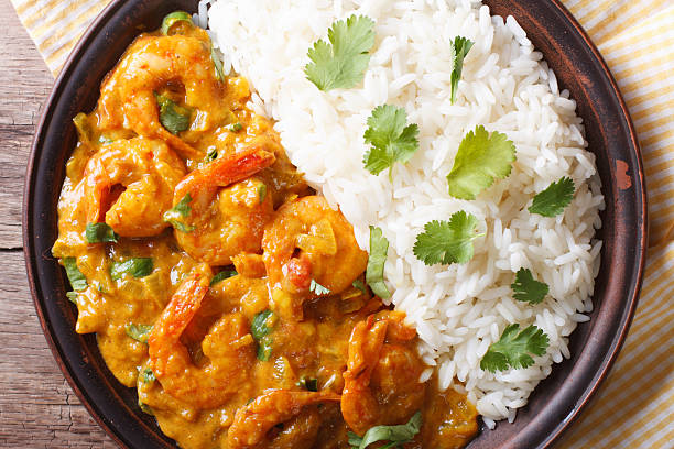 istock Shrimps in curry sauce and rice close-up. horizontal top view 479660420