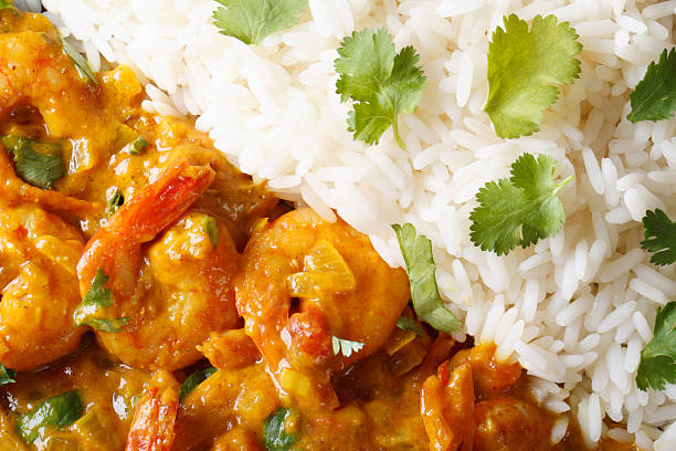 istock Shrimps curry with rice and cilantro macro. horizontal top view 479660756