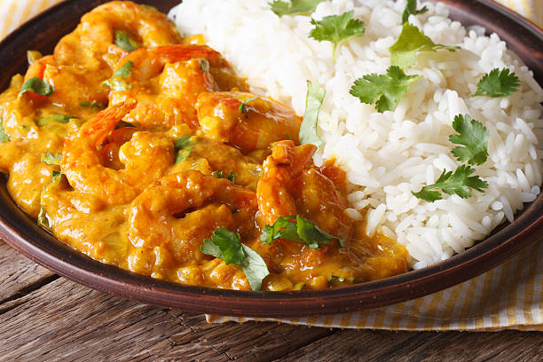 istock Shrimps in curry sauce with rice and cilantro horizontal 479661166