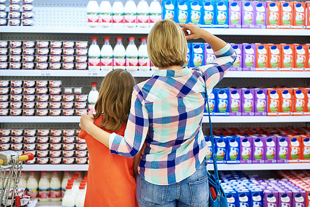 istock Mother and daughter choosing dairy products 479661302