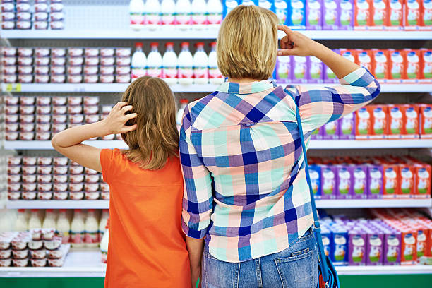 istock Mother and daughter choosing dairy products 479661322