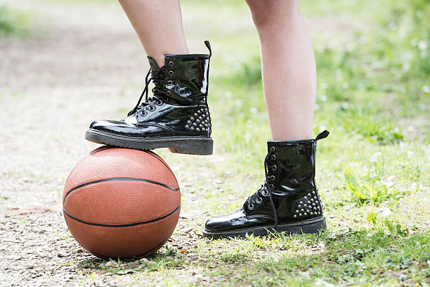 istock Girl holding a basket ball under her boot 479661368