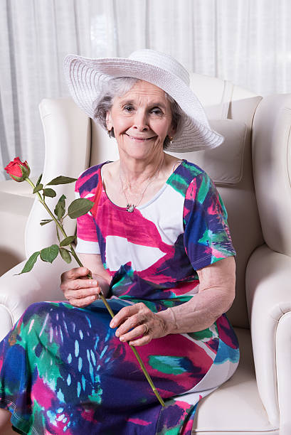 istock active female senior with rose in her hand 479665952