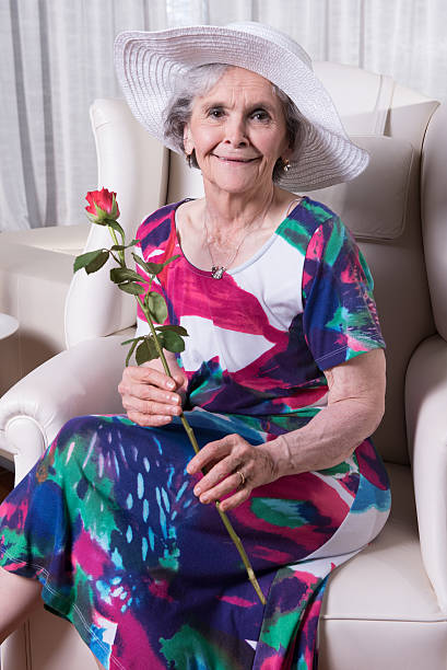 istock active female senior with rose in her hand 479665954