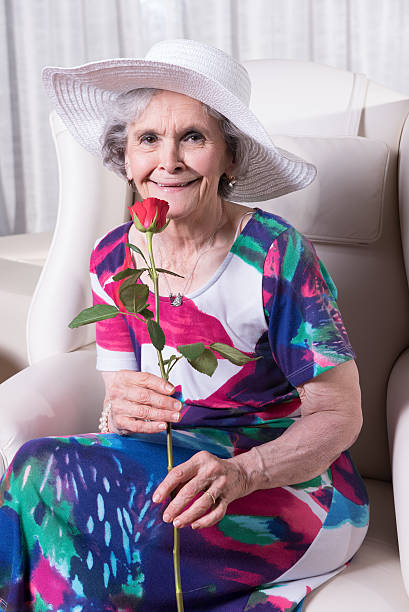 istock active female senior with rose in her hand 479666044