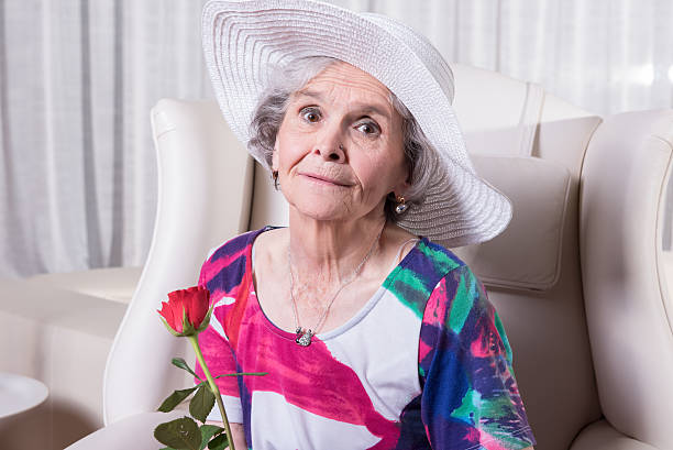 istock active female senior with rose in her hand 479666090