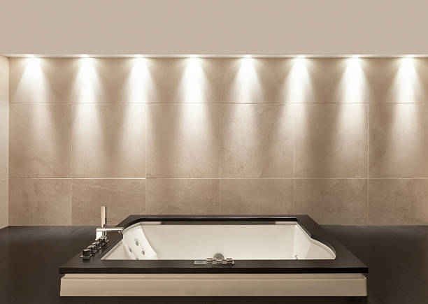 3D rendering of a bathroom during night. Computer generated image of a modern bathroom interior with toilet and bathtub.