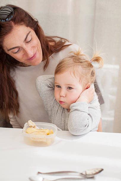 istock baby eating from tupperware with mother 479680550