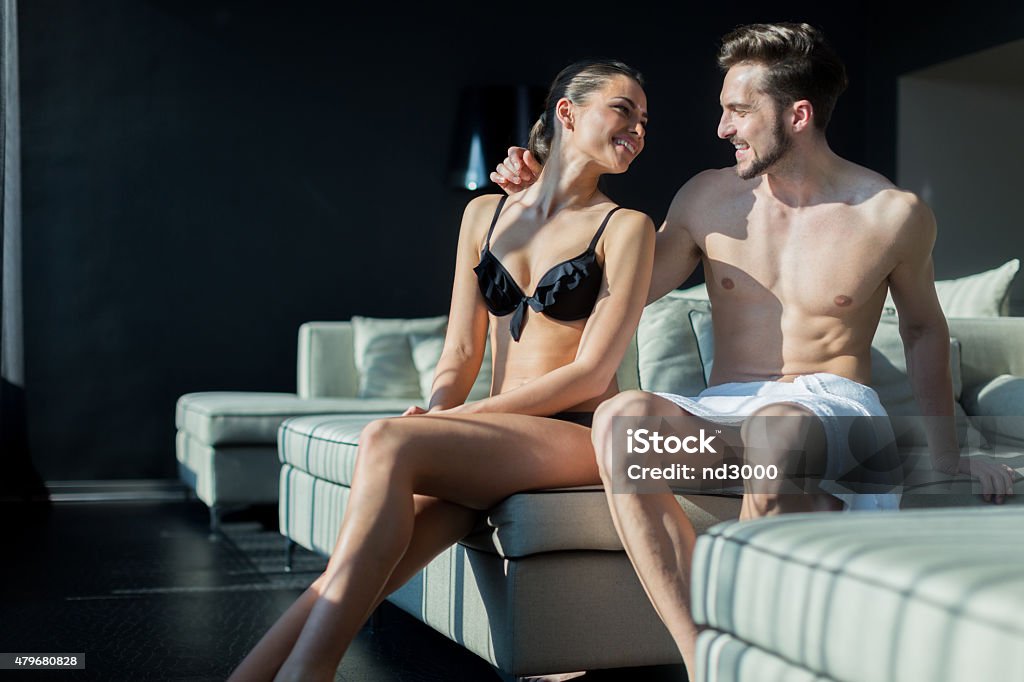 Beautiful couple being in love on their honeymoon in hotel Beautiful couple being in love on their honeymoon in a luxurious hotel room while being half naked 2015 Stock Photo