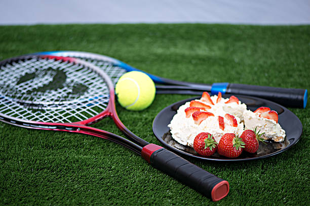 Strawberries and Cream Strawberries and Cream with tennis raquets and ball wimbledon stock pictures, royalty-free photos & images