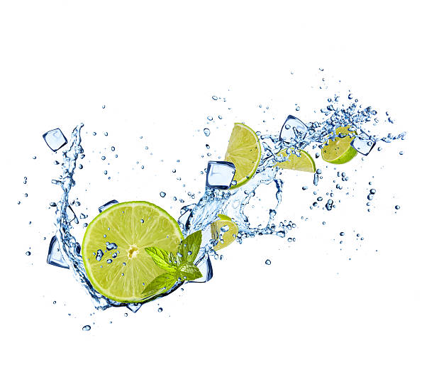 istock Limes slices in water splashes on white background 479688312