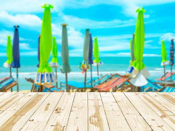 istock Wood table top on sea beach with umbrella blurry backgrounds. 479696860