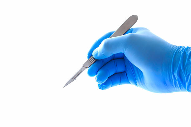 Doctor's hand holding tweezers with clipping path Doctor's hand holding a scalpel with clipping path scalpel photos stock pictures, royalty-free photos & images
