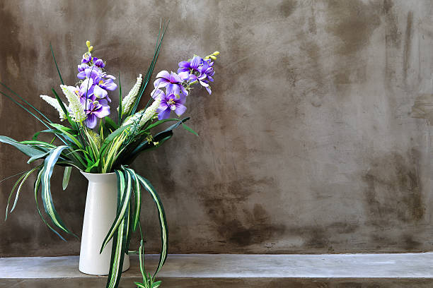 istock Bouquet of peonies in a vase against  wall. Interior 479710567