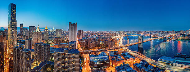 New York City Panoramic Aerial View at Dusk New York City Panoramic Aerial View at Dusk from Downtown looking towards midtown with views of Brooklyn Bridge, Manhattan bridge and the Empire State Building. williamsburg bridge photos stock pictures, royalty-free photos & images