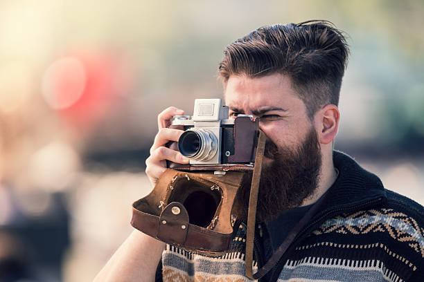 istock Trendy hipster young man with old camera 479712846