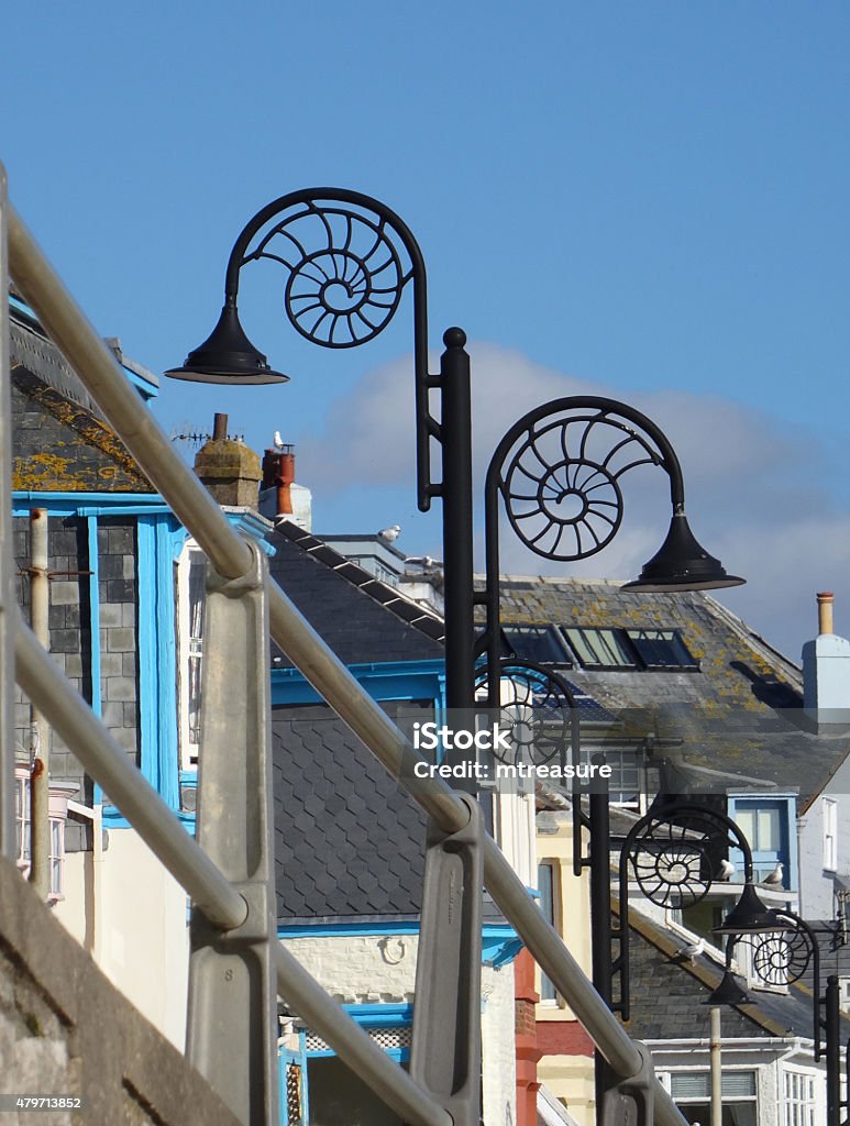 Image of black ammonite street lamps in Lyme Regis, Dorset Photo showing some street lamps in the shape of ammonite fossils, in the seaside town of Lyme Regis, Dorset, England. Jurassic Coast World Heritage Site Stock Photo