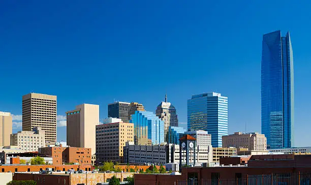 Oklahoma downtown skyline with a deep blue sky, featuring the new Devon Energy Center building.