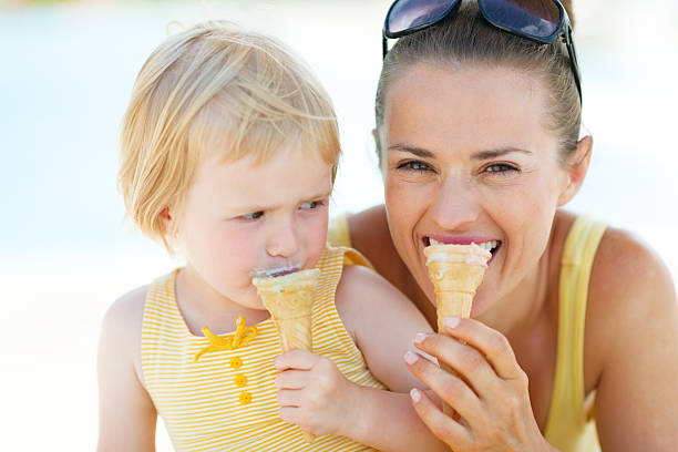 istock mother and baby biting ice cream 479714937