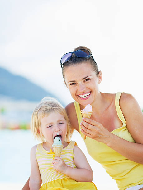 istock smiling mother and baby eating ice cream 479714953