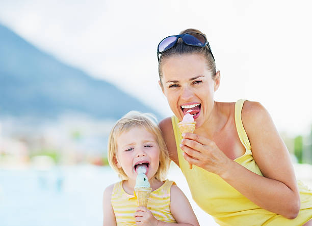 istock happy mother and baby eating ice cream 479714959