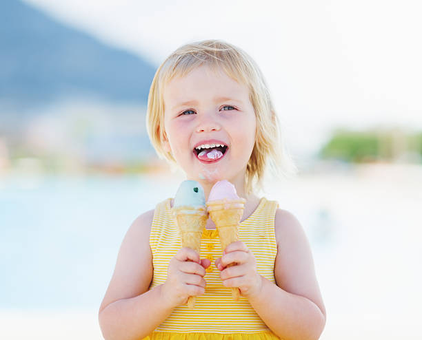 istock happy baby eating two ice cream 479715023