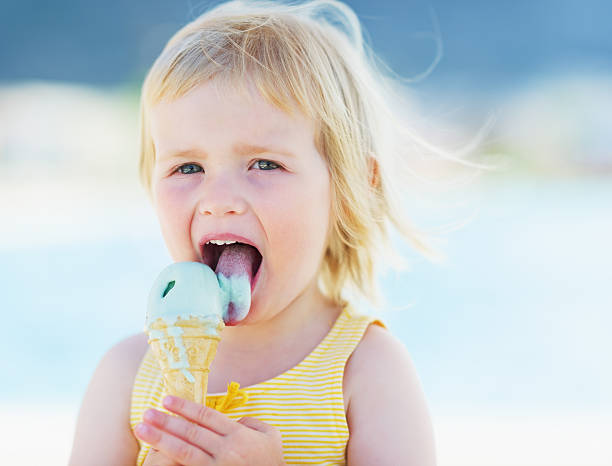 istock happy baby eating ice cream 479715025