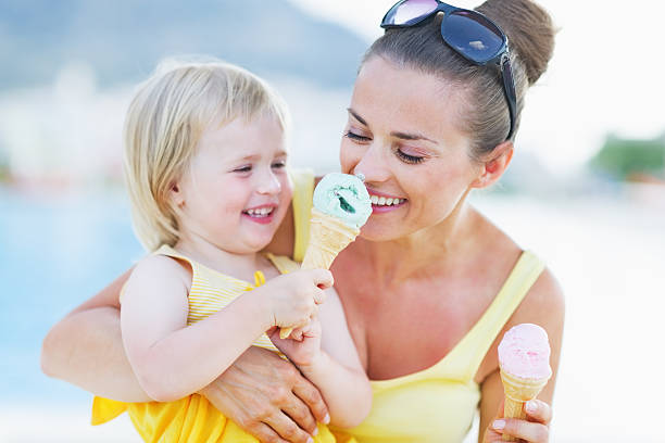 istock smiling baby giving mother ice cream 479715027