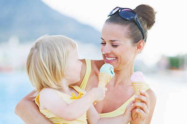 istock smeared mother and baby eating ice cream 479715031
