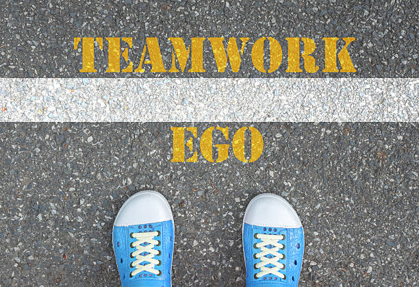 istock Shoes standing at the line between ego and teamwork 479718122