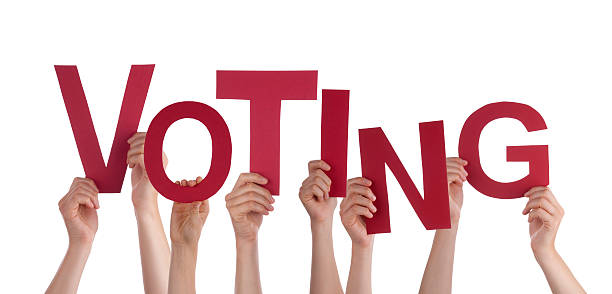 istock Many People Hands Holding Red Word Voting 479723932