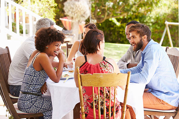 istock Friends dining together at a table in a garden 479724682
