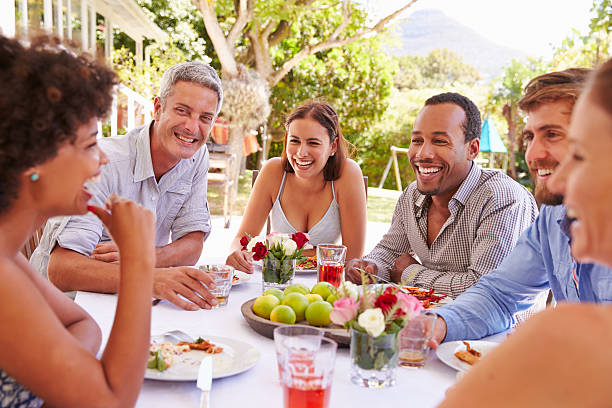 istock Friends dining together at a table in a garden 479724690