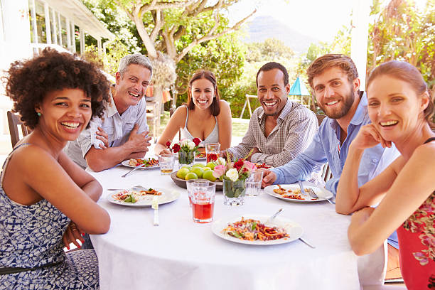 istock Friends dining together at a table in a garden 479724692