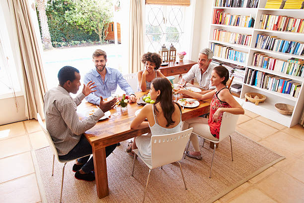 istock Friends sitting at a table talking during a dinner party 479725028
