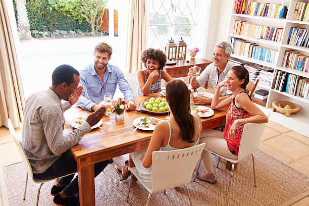 istock Friends sitting at a table talking during a dinner party 479725098