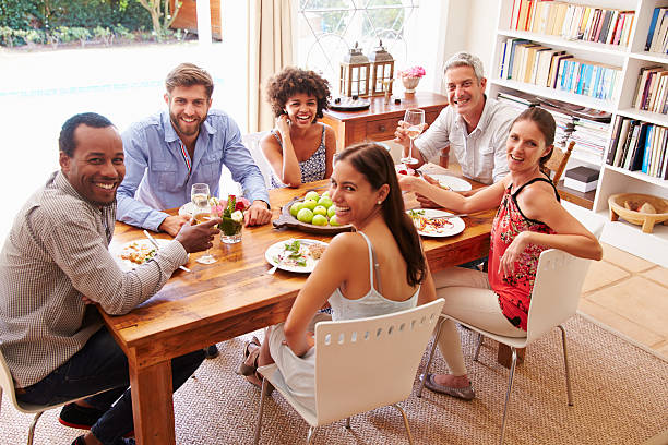 istock Friends sitting at a dining table looking at the camera 479725106