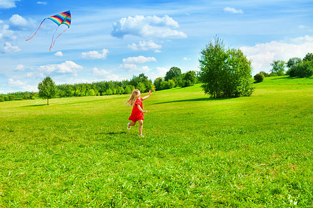 istock Girl running with kite 479726097