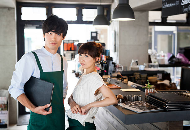 istock Young asian waiters standing next to a bar counter 479726670