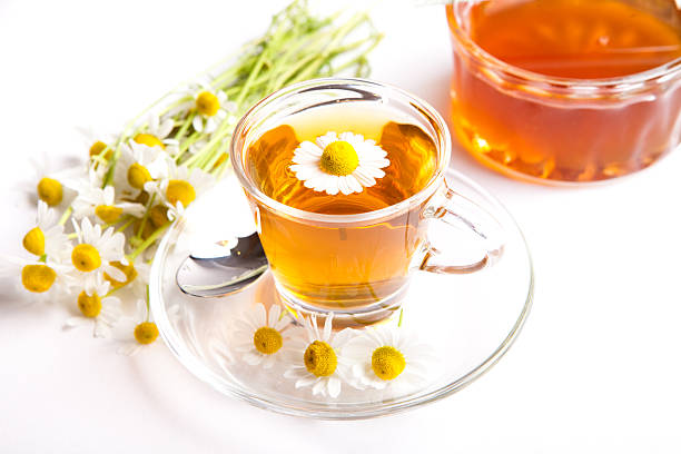 istock chamomile tea with blooming herbs and honey on white background 479728864