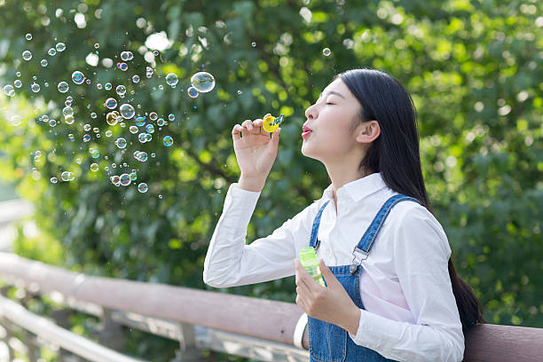 istock pretty girl blowing bubbles 479728904