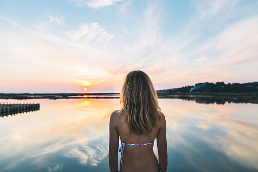 beautiful woman enjoying sunset lagoon