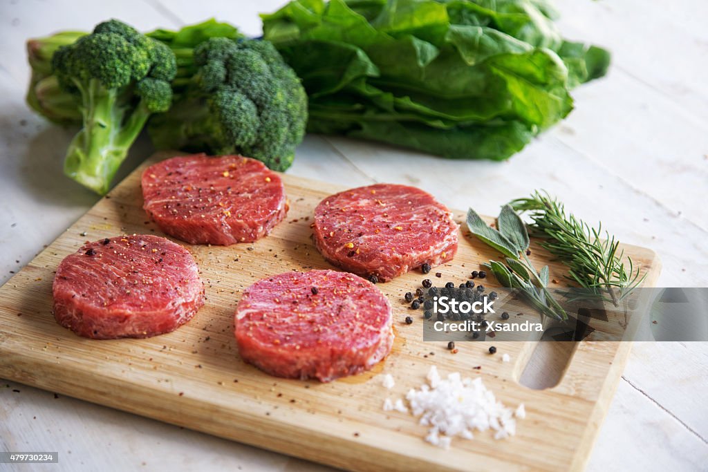 Wagyu beef steaks Premium raw Japanese beef steaks on cutting board with seasoning, broccoli and spinach Kobe - Japan Stock Photo