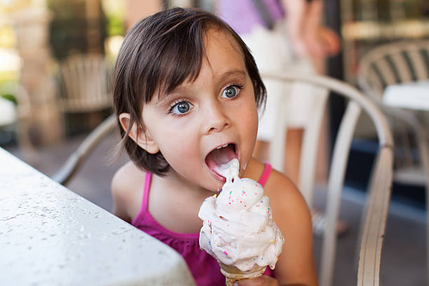 istock Little Girl is Licking an Ice Cream 479730656