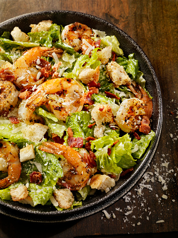 Caesar Salad with Romain Lettuce, Bacon, Capers, Croutons, Freshly Grated Parmesan Cheese and a Toasted Baguette  -Photographed on Hasselblad H3D2-39mb Camera