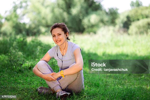 Woman Exercising Outdoors With Headphones Stock Photo - Download Image Now - 2015, Active Lifestyle, Activity