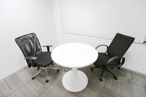 Discussion room with round table and two chairs.