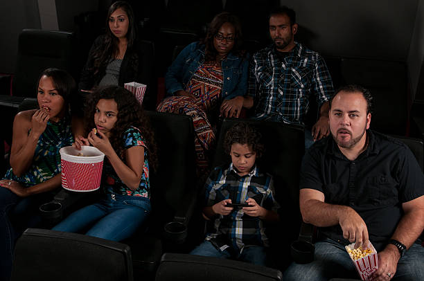 istock Child playing on cell phone during a movie 479739904