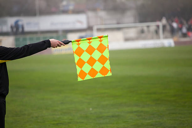 árbitro de futebol segure a bandeira.  impedimento armadilha - referee soccer authority linesman - fotografias e filmes do acervo