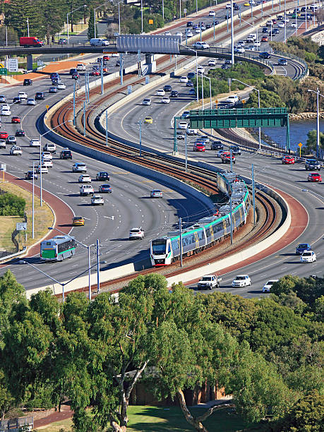 istock Efficient city transport: train down freeway median strip 479759060
